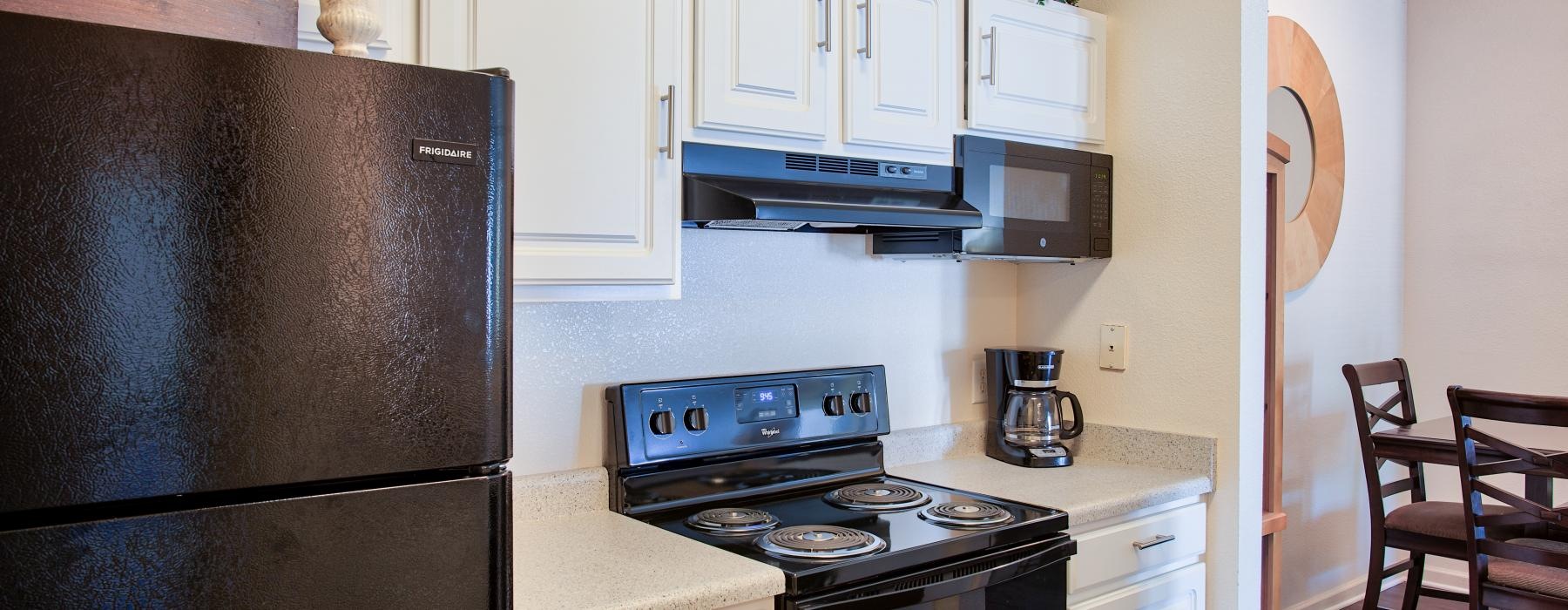 a kitchen with white cabinets